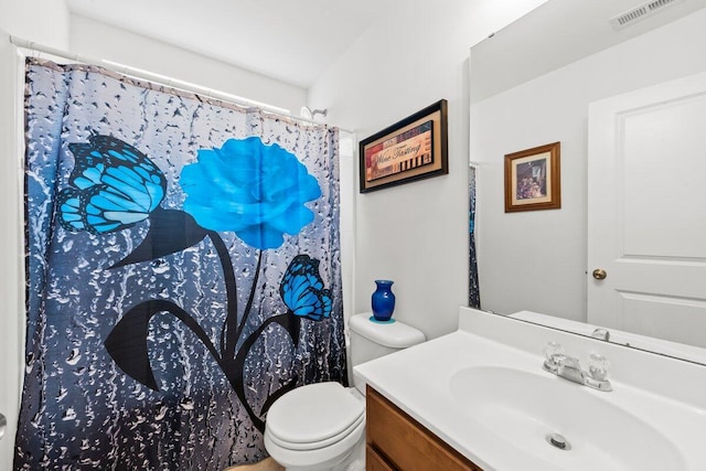 bathroom with toilet, curtained shower, visible vents, and vanity