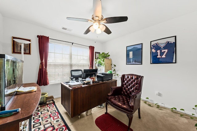 office featuring visible vents, ceiling fan, light carpet, and baseboards