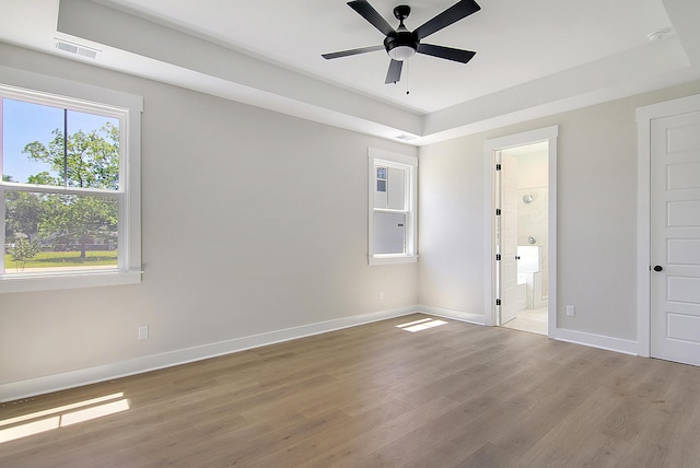 unfurnished room featuring visible vents, ceiling fan, light wood-style flooring, and baseboards