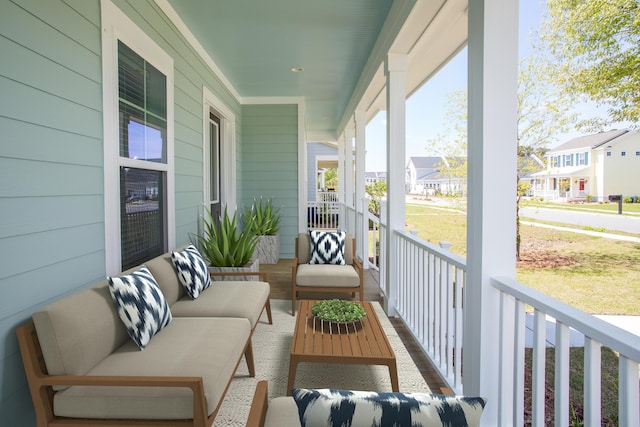 balcony with a porch, a residential view, and an outdoor hangout area