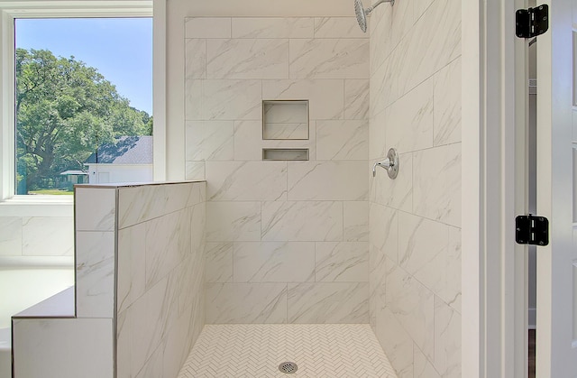 bathroom with plenty of natural light and a tile shower