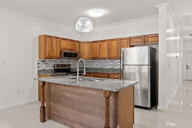 kitchen with dark stone counters, stainless steel appliances, sink, and tasteful backsplash