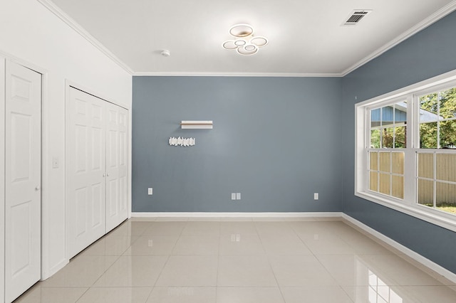 unfurnished bedroom with light tile patterned flooring and crown molding