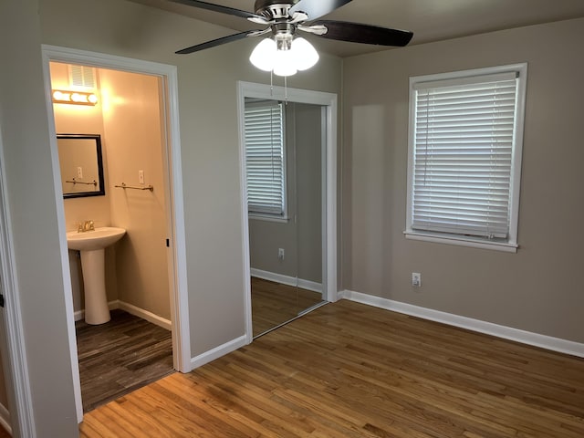 105 Pandora Dr, Goose Creek, SC 29445 - unfurnished bedroom with wood finished floors, baseboards, a sink, a closet, and ensuite bath