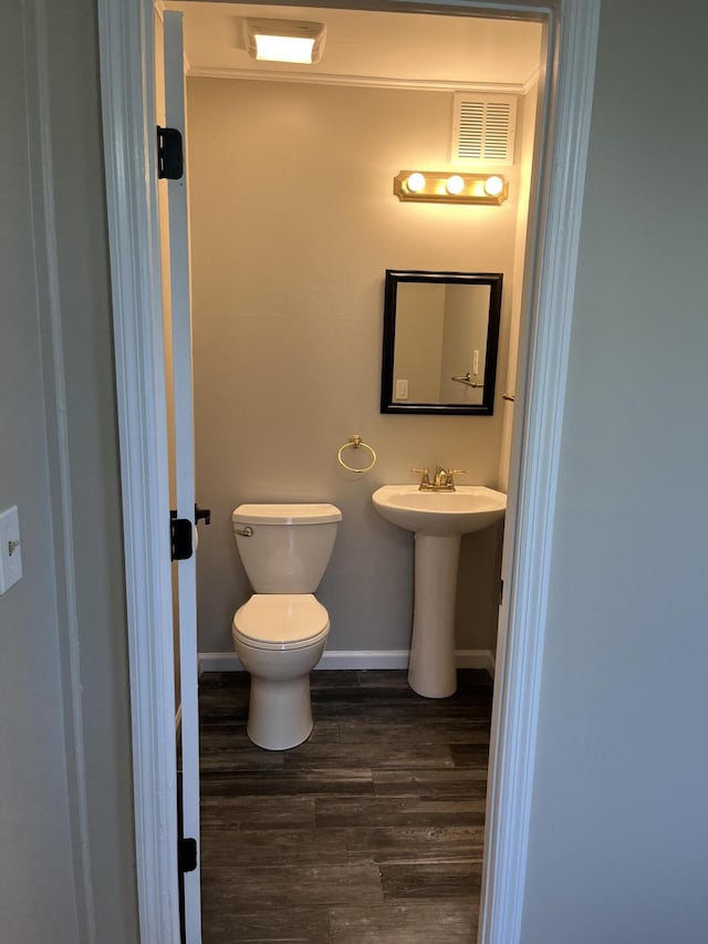 105 Pandora Dr, Goose Creek, SC 29445 - half bathroom featuring toilet, wood finished floors, baseboards, and a sink