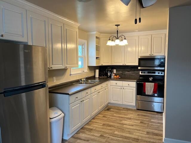 105 Pandora Dr, Goose Creek, SC 29445 - kitchen featuring appliances with stainless steel finishes, a sink, dark countertops, light wood-style flooring, and white cabinetry