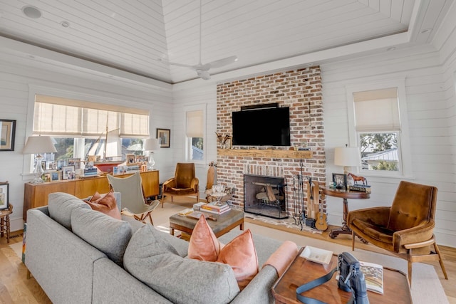 living room with a fireplace and light wood-type flooring