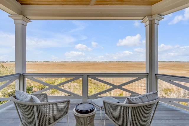 wooden deck with a rural view