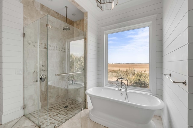 bathroom featuring tile patterned floors and separate shower and tub