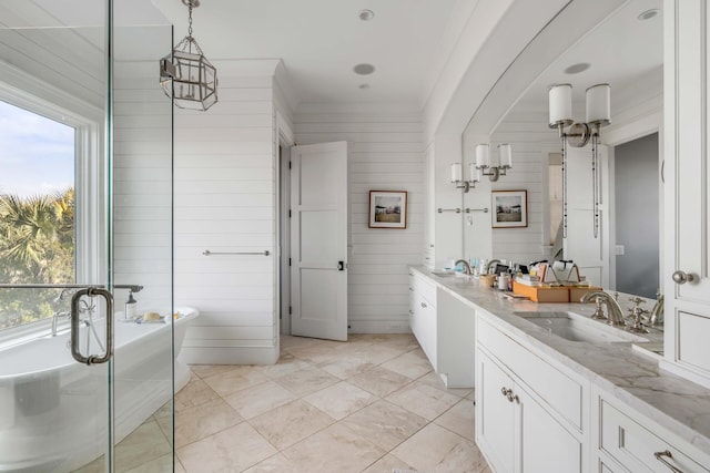 bathroom featuring vanity, tile patterned floors, a bathing tub, and wood walls