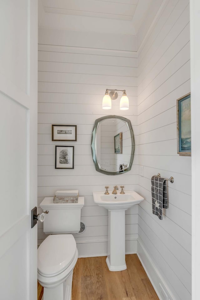 bathroom with sink, hardwood / wood-style flooring, and toilet