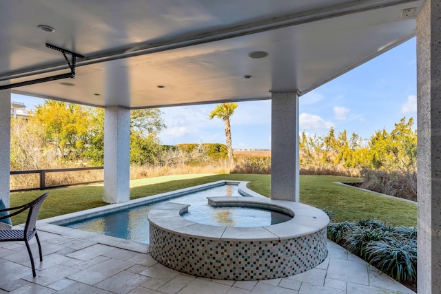 view of patio / terrace featuring a pool with hot tub