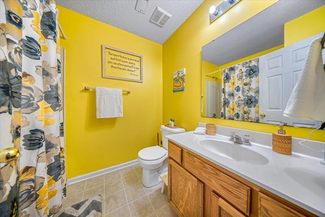 full bathroom featuring vanity, baseboards, tile patterned flooring, a textured ceiling, and toilet