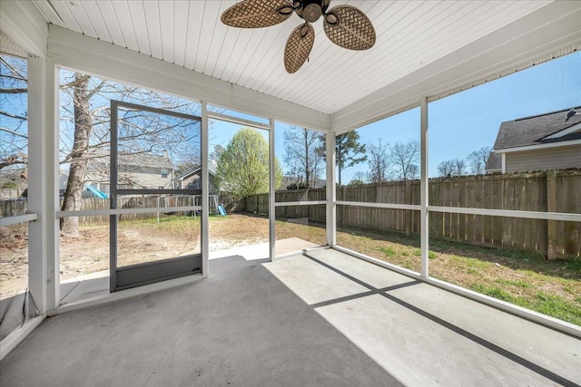 unfurnished sunroom with ceiling fan