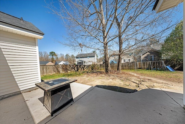 view of patio with a residential view, a playground, and a fenced backyard