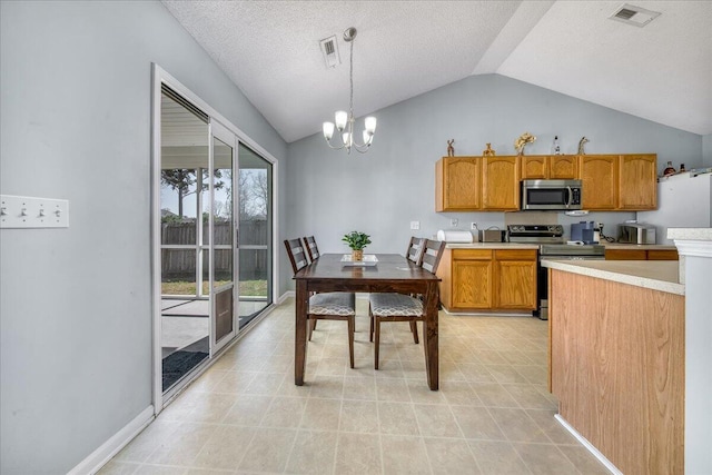 kitchen with visible vents, an inviting chandelier, light countertops, appliances with stainless steel finishes, and decorative light fixtures