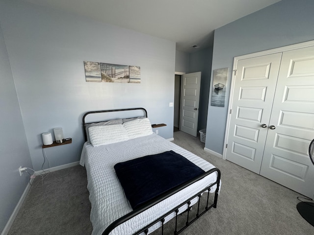 bedroom with carpet floors, a closet, and baseboards