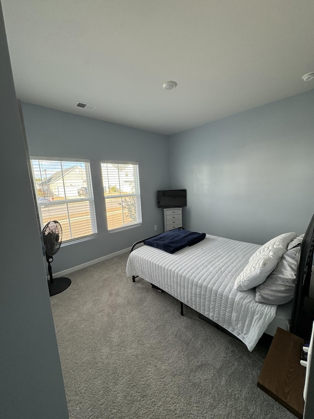 bedroom featuring baseboards, visible vents, and carpet flooring