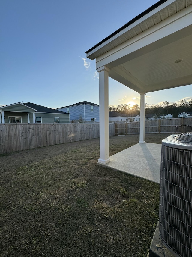 view of yard featuring a patio area, a fenced backyard, and central AC