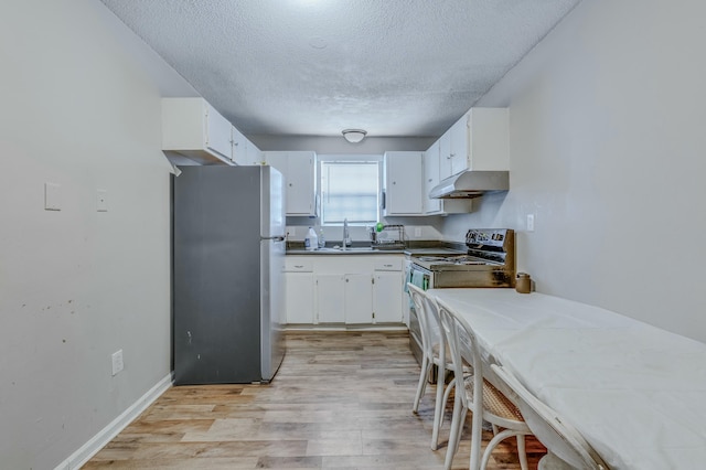 kitchen featuring sink, a textured ceiling, light wood-type flooring, appliances with stainless steel finishes, and white cabinets