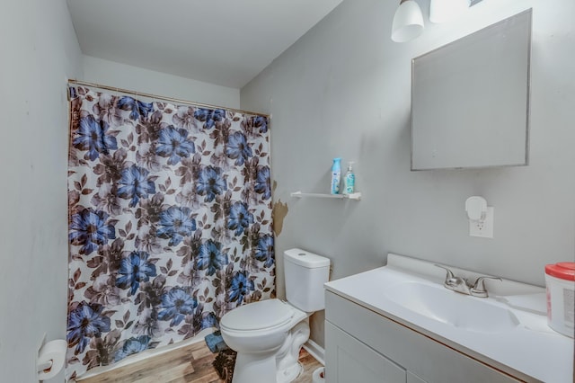 bathroom with a shower with curtain, vanity, hardwood / wood-style floors, and toilet