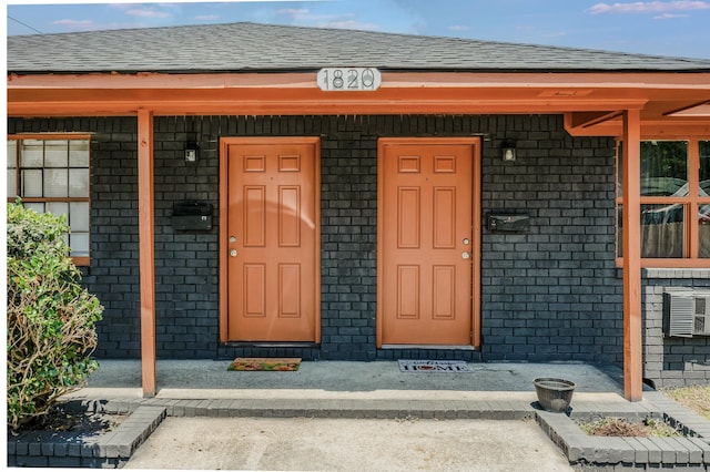 view of exterior entry with covered porch