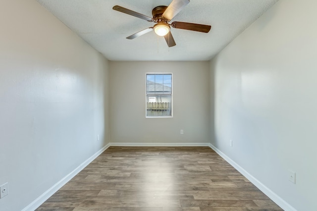 spare room featuring ceiling fan, light hardwood / wood-style floors, and a textured ceiling