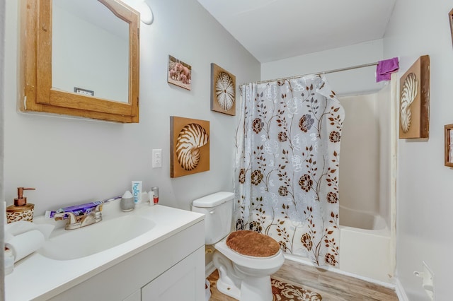 full bathroom with toilet, vanity, shower / bathtub combination with curtain, and hardwood / wood-style flooring