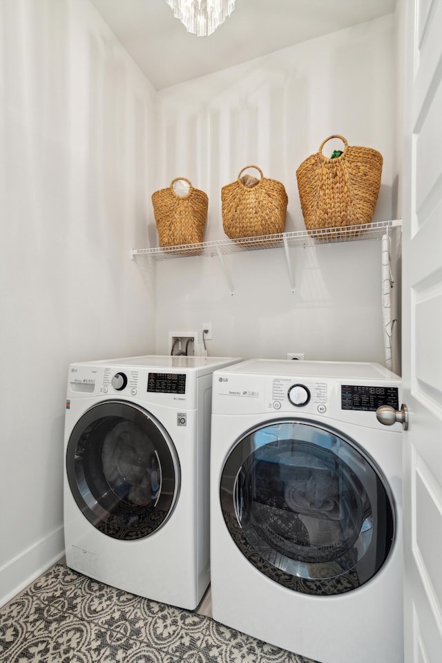 clothes washing area featuring light tile patterned flooring and independent washer and dryer