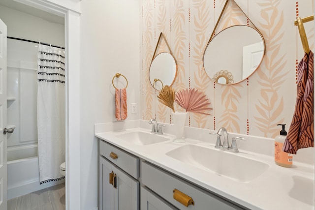 full bathroom featuring vanity, shower / bath combination with curtain, and toilet