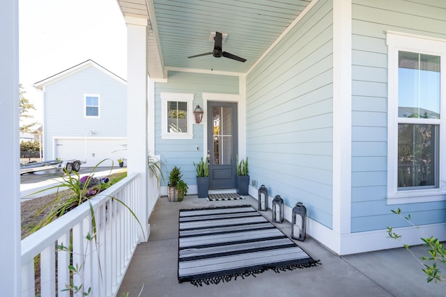 view of exterior entry featuring a porch and ceiling fan