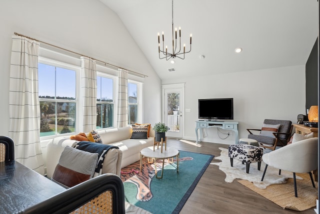 living room with a notable chandelier, dark wood-type flooring, and high vaulted ceiling