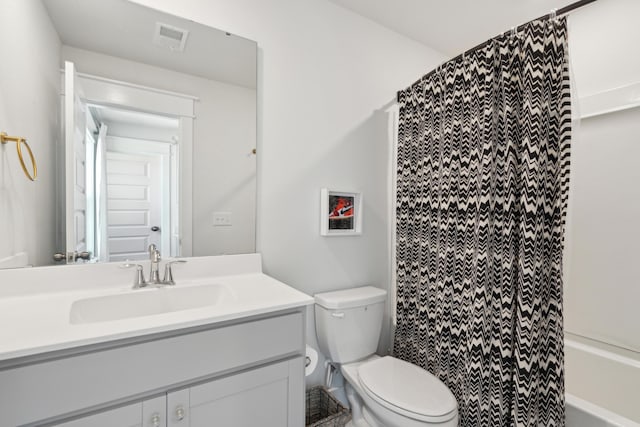 full bathroom featuring vanity, shower / tub combo, and toilet