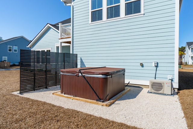 exterior space with a hot tub and ac unit