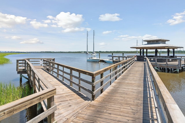 view of dock with a gazebo and a water view