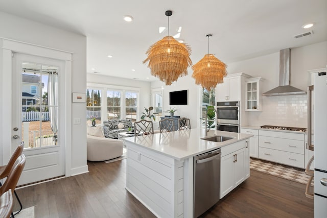 kitchen with white cabinetry, sink, wall chimney exhaust hood, and appliances with stainless steel finishes