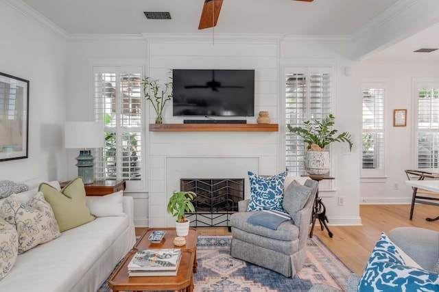 living room with ornamental molding, ceiling fan, and hardwood / wood-style floors