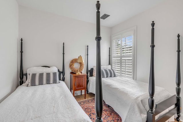 bedroom with hardwood / wood-style flooring