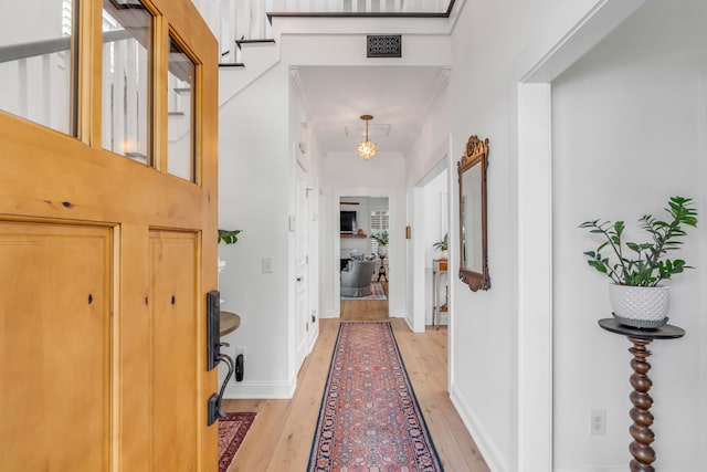 hallway with light hardwood / wood-style floors