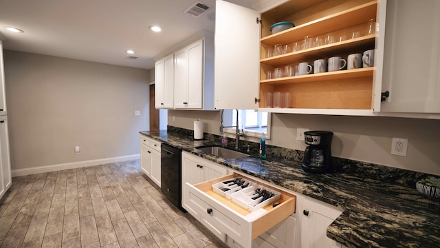 kitchen with white cabinetry, black dishwasher, light wood-type flooring, and dark stone counters