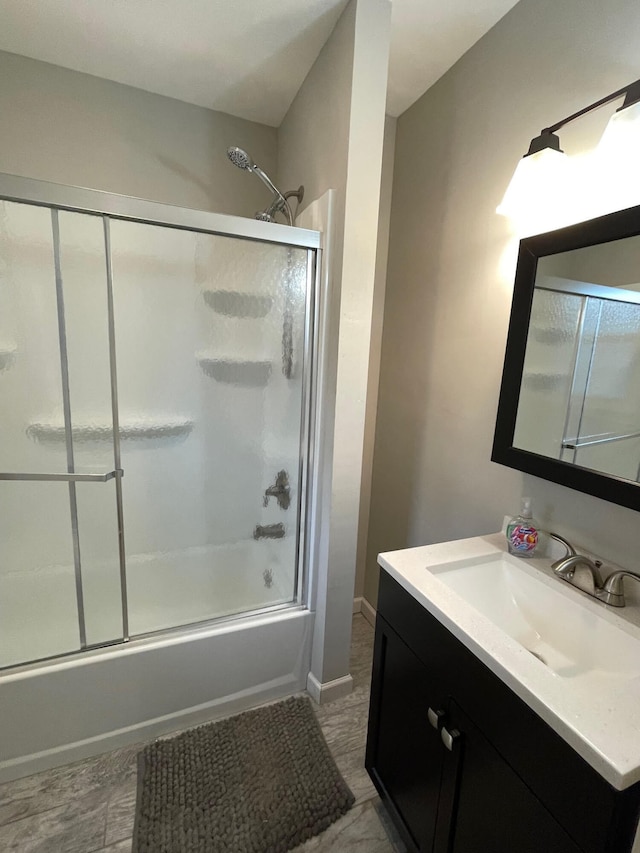 bathroom with vanity and bath / shower combo with glass door