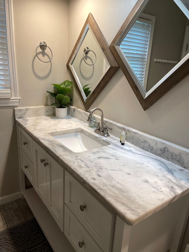 bathroom with vanity and wood-type flooring