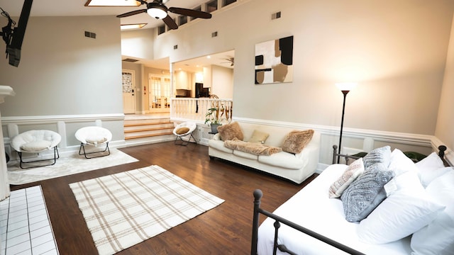 living room featuring high vaulted ceiling and dark wood-type flooring