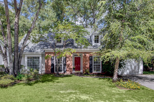 view of front of home with a front yard and a garage