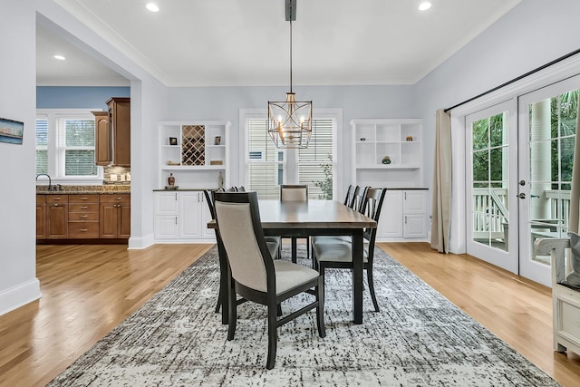 dining room with plenty of natural light, a chandelier, and light hardwood / wood-style flooring