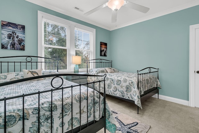 bedroom with carpet flooring, ceiling fan, and ornamental molding