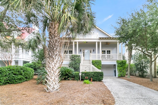 view of front facade featuring covered porch, a garage, and ceiling fan