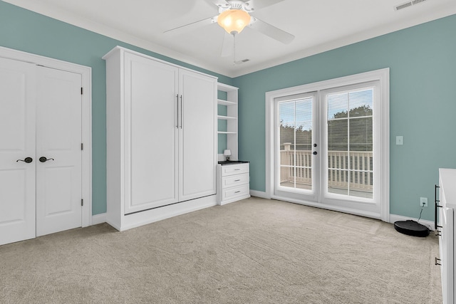 unfurnished bedroom featuring light carpet, access to exterior, and ceiling fan