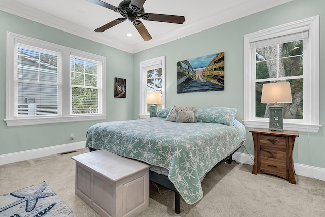 carpeted bedroom featuring ceiling fan and ornamental molding