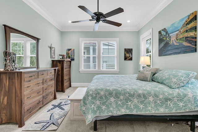 carpeted bedroom featuring ceiling fan and crown molding